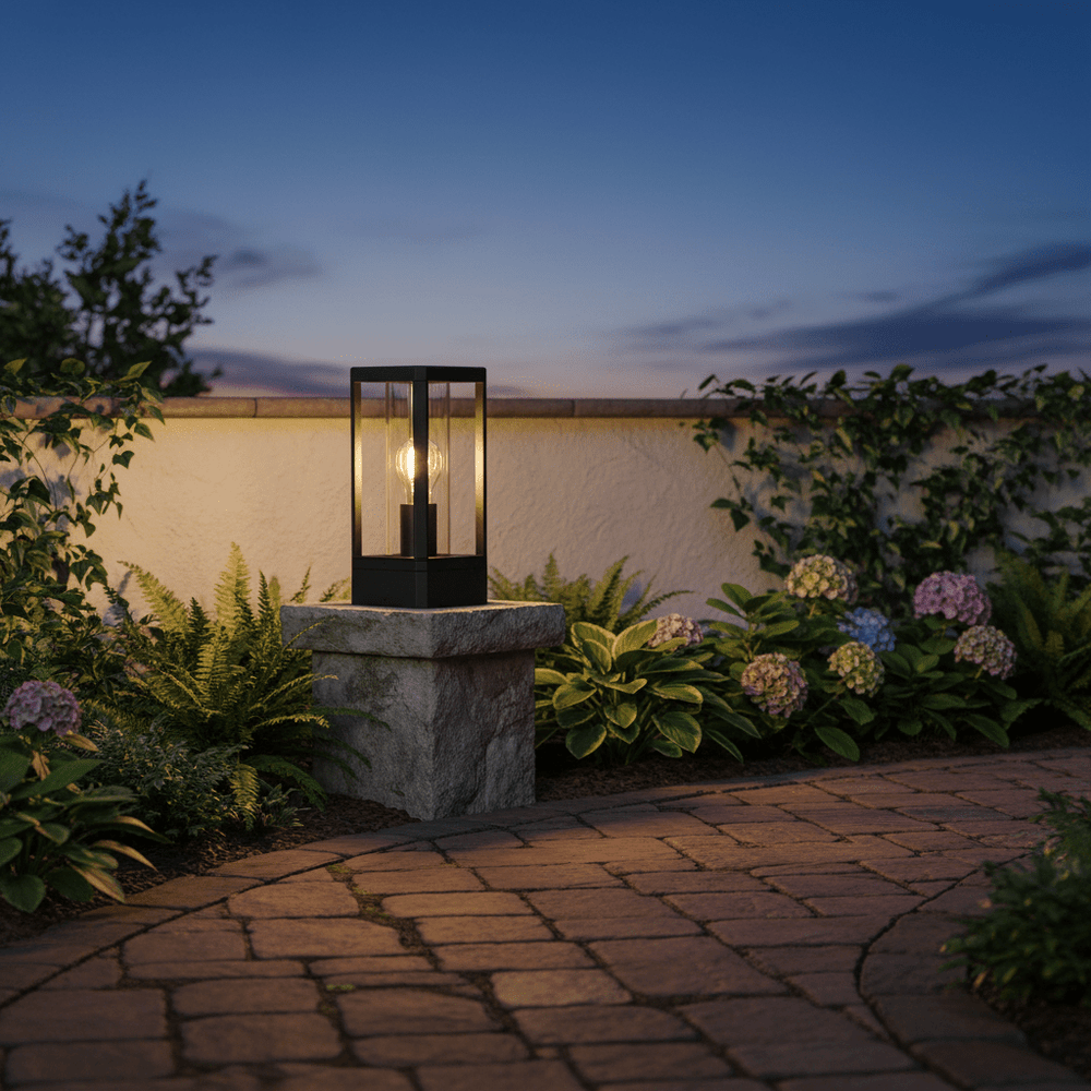 Bhok Ali Square Outdoor Post Top Light on a stone pillar, surrounded by lush greenery and flowers, at dusk.