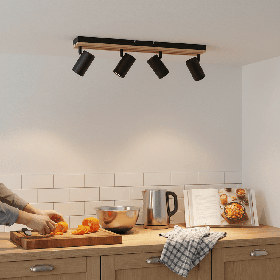 Four-light GU10 spotlight mounted above a kitchen counter, illuminating food preparation