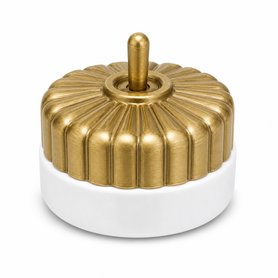 Heritage brass and porcelain fluted switch on a white background