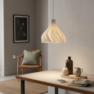 Stylish white pendant light hanging above a modern table with decorative items and a cozy chair.