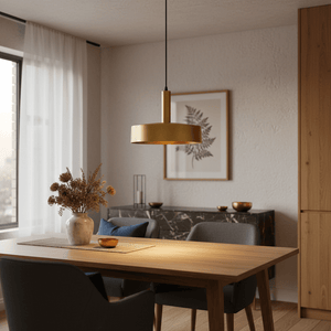 Sombre Gold Pendant light hanging above a wooden dining table with decorative vase and tableware.