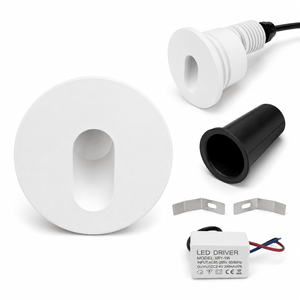 Components of a white LED round recessed step light including housing, LED driver, and installation clips.