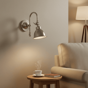 Stylish indoor wall lamp with a metal cone shade, illuminating a cozy seating area with a steaming cup.