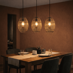 Three Twine Pendant Coffee lights hang above a wooden dining table set with plates and glasses.