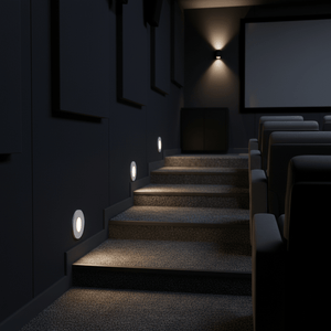 Recessed LED step lights illuminate a dark staircase in a modern setting, enhancing safety and ambiance.