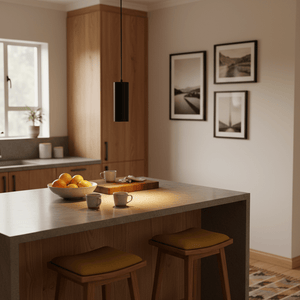 Minimalist kitchen scene featuring a Solo Round Aluminium Pendant light above a countertop with fruit and mugs.