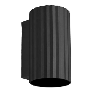 Black ribbed cylindrical wall light with side mounting bracket, shown against a green background.