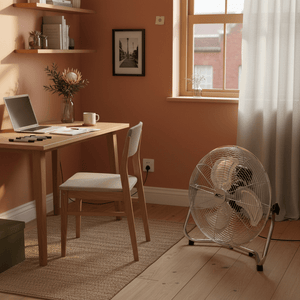 Industrial floor fan placed in a cozy home office with wooden desk and chair.