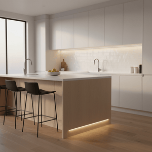 Modern kitchen with a wooden island featuring subtle under-counter LED lighting, complemented by sleek black stools.