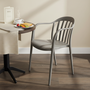 Warm grey Old School Chair beside a breakfast table with food and drinks, showcasing its design and setting.