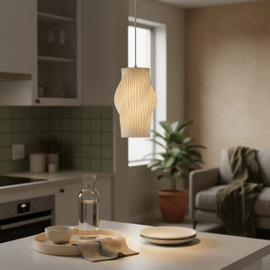 A modern white pendant light hangs above a dining table with a water carafe and plates, creating a serene atmosphere.