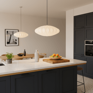 Stylish kitchen scene featuring two Silk Pendant Lights above a marble countertop with a fruit bowl.
