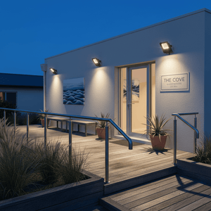 Coastal floodlight illuminating the entrance of a guesthouse, enhancing visibility on the wooden deck.