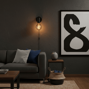 Slick Indoor Wall Lamp mounted on a textured wall, illuminating a cozy lounge area with a sofa and decorative elements.