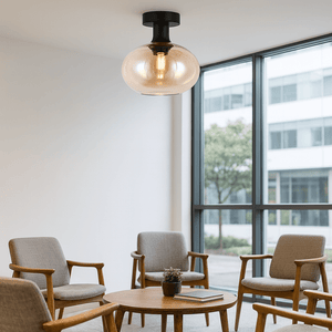 Amber glass orb ceiling light mounted in a modern lounge with wooden furniture and large windows.