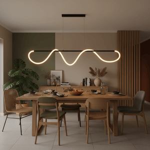 Modern pendant light with a wavy design suspended above a wooden dining table set with dishes.