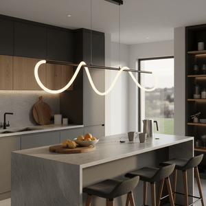 Modern pendant light with flexible linear design illuminating a kitchen island with fruit and coffee.