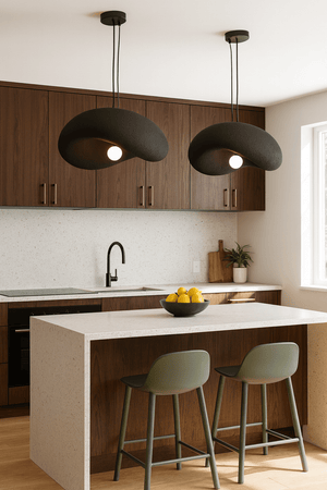 Two Obsidian Drift 500 Pendant Lights hanging over a modern kitchen island with a bowl of lemons.