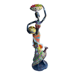 Colorful African female figurine holding a fruit-filled bowl on her head