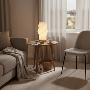 Dahlia 3D Printed Table Lamp on a wooden side table beside a cozy sofa, with a cup and magazine.