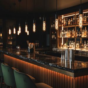 Bar counter with bottles and lighting fixtures in a dimly lit bar setting