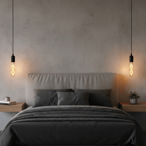 Amber LED filament bulb in a stylish bedroom setting, illuminating a cozy bed with dark linens.