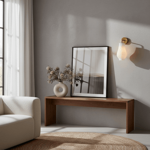 Stylish indoor scene featuring the Bluebell wall light beside a wooden console table with decorative vase and artwork.