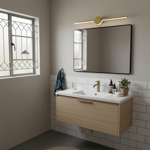 Gold slim LED linear light mounted above a modern bathroom mirror, illuminating the space.