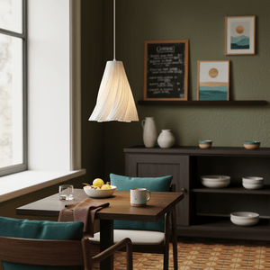 Stylish white pendant light hanging above a dining table with a bowl of lemons and a coffee mug.