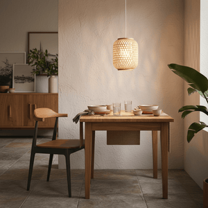 Natural twine pendant light hanging above a wooden dining table set with dishes and glasses.