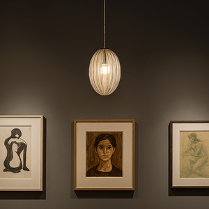 Artistic wall display with framed artworks and a pendant light fixture.