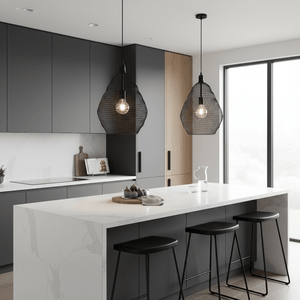 Two black wire-mesh pendant lights hang over a modern kitchen island with a marble countertop.