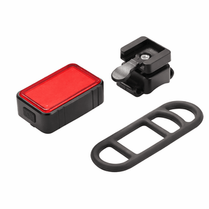 LED bicycle light with gravity-activated brake feature, includes mounting bracket and rubber strap.