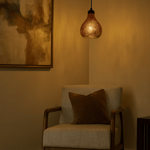Cozy corner with a chair, cushion, and hanging light fixture in a warm room.