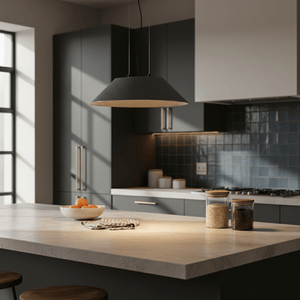 Grey felt pendant hanging over a kitchen island with jars and fruit