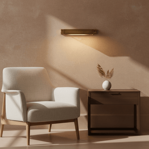 Antique brass wall lamp illuminating a cozy seating area with a chair and side table.