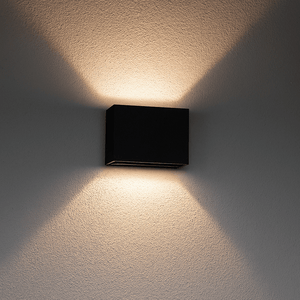Black square wall light fixture on a textured wall