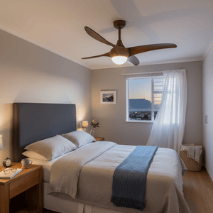 A modern bedroom featuring a ceiling fan with wood finish, illuminating the space with soft light.