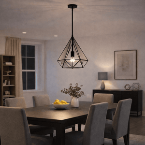 Geometric metal pendant light hanging above a dining table with a bowl of lemons.