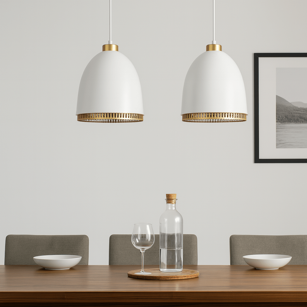 Two white pendant lights with gold accents hanging above a dining table.