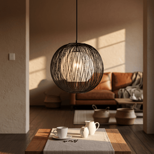 Stylish pendant light with black bamboo outer and natural twine inner, illuminating a cozy living space.