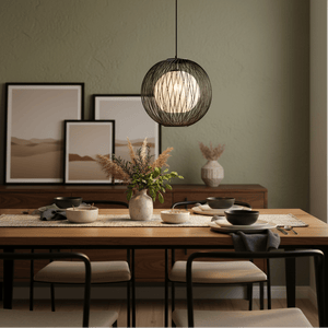 Stylish pendant light with black bamboo outer and natural twine inner, hanging above a dining table set.