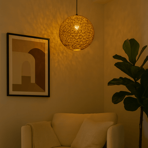 Living room with a beige sofa, textured pendant light, and abstract art on the wall.