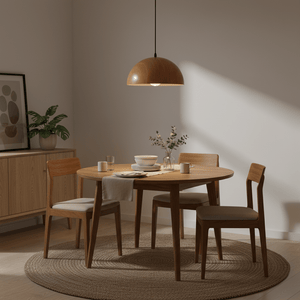 Wood grain pendant light hanging above a round dining table set with dishes and a vase, creating a warm ambiance.