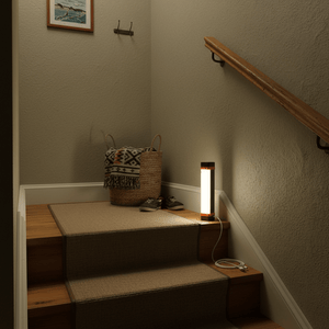 Rechargeable LED camping lantern illuminating a staircase, with a basket and shoes nearby.