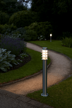 Garden path illuminated by an led bollard, stainless steel.