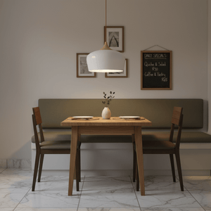Scandinavian-style pendant light above a wooden dining table with green bench seating and decorative vase.
