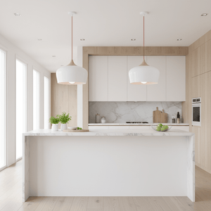 Scandinavian-style pendant lights hang over a modern kitchen island with a marble countertop.