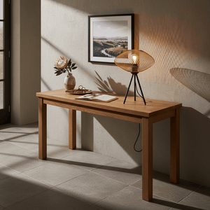 Gold mesh table lamp on a wooden console table with a vase and an open notebook.