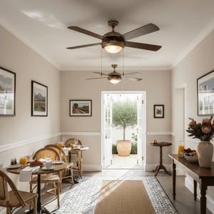 Antique brass ceiling fan with five blades in a bright dining area, enhancing the space's ambiance.